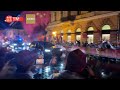 People wave national flags to welcome Xi Jinping in Budapest