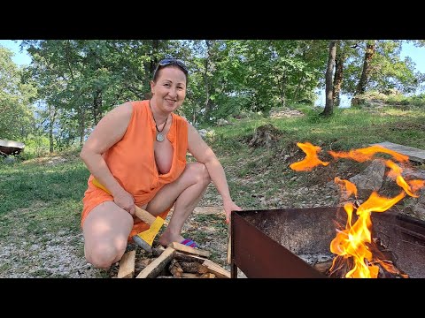 Wood cutting  Mila. cooking on an open fire. Mila's Naturist Cooking. Mila naturist.