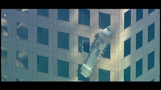 Two workers almost fall off building in Manhattan