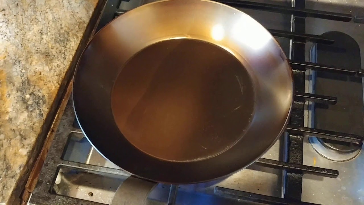 108. Season carbon steel frying pan using both the oven method and wok