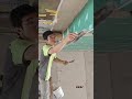 the process of plastering smooth cement on the corners of the boards on the ceiling of a building