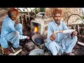 Wonderful skilled old Blacksmith making handmade sharp knife