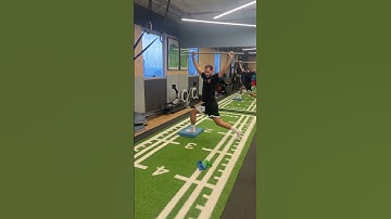 Overhead rotation with stick in split squat low position with balance pad