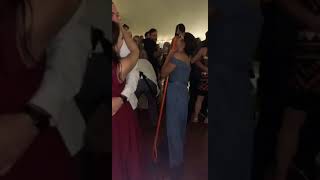 Bridesmaid is dancing with a mop.