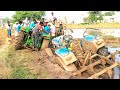 New holland and JohnDeere tractors stuck in mud