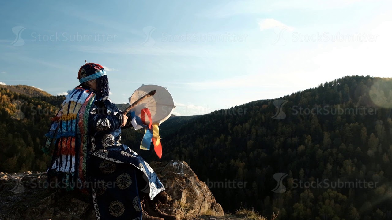 The old wizard knocks on the drum and communicates with the spirits of the forest sitting on the top