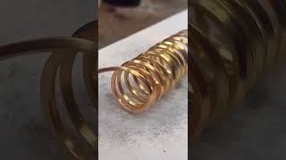 Heating up a pure gold spring coil #puregoldjewelry #cubanlinkchain #goldcoil #goldspring