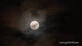 Time lapse of the full moon passing behind clouds