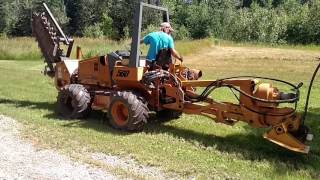 Case 560 plow/trencher plowing 1&quot; water line at 36&quot; deep in Rocky clay soil