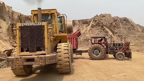 CAT 966M Front Loader Handling Stones EfficientlyQuarry Work: Caterpillar Machine Loading Dump Truck