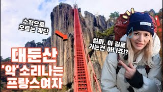 A French woman climbing the vertical stairs of Daedunsan Mountain in Korea