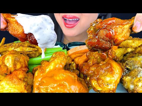 EATING SPICY FRIED WINGS DIPPED IN SAUCE