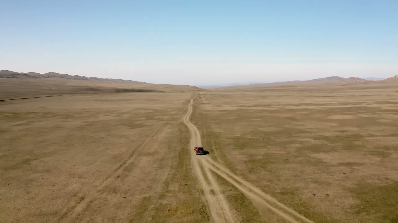 Adventure in the Rugged Mountains With Offroad Car Traversing Vast Desert Terrain at Sunset