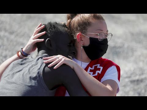 Red Cross worker embraces tearful Ceuta migrant