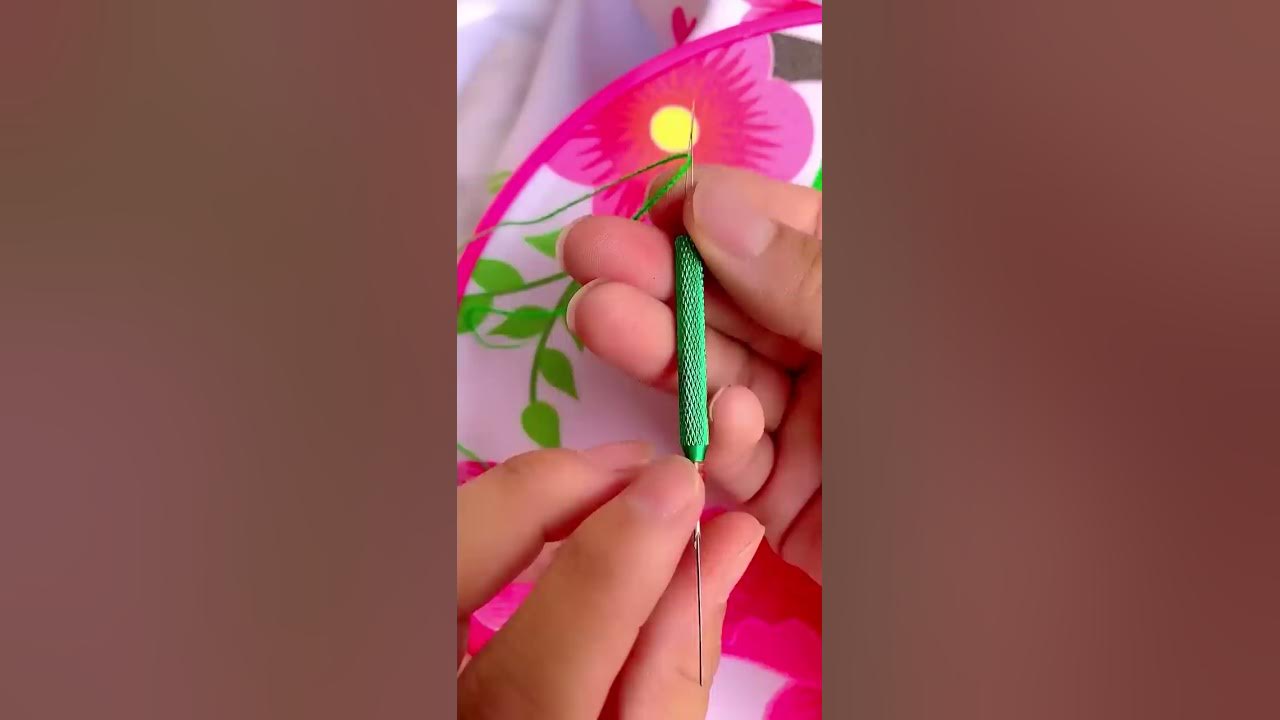 The threading of an embroidery needle
