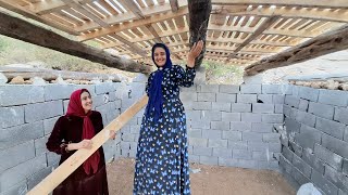 Rahleh covering the roof and Narges' joy at the completion of her house