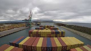 Container Ship 9400 TEU is unberthing in Gioia Tauro. Strait of Messina transit. Timelapse.
