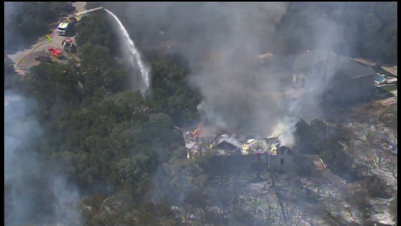 Crews working to extinguish large grass fire that spread to North Side ...