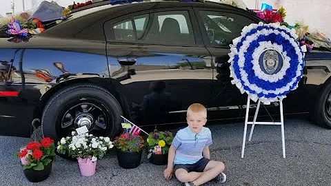 Officers walk 5-year-old boy to school after father dies in line of duty