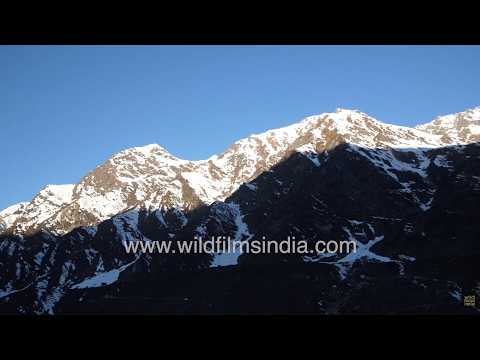 Morning sunlight illuminates the snow-covered Kedarnath Massif in Uttarakhand