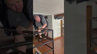 Guy walks through low ceiling room with beds