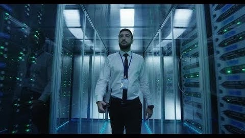 Engineer Walking Among Server Racks (Stock Footage)