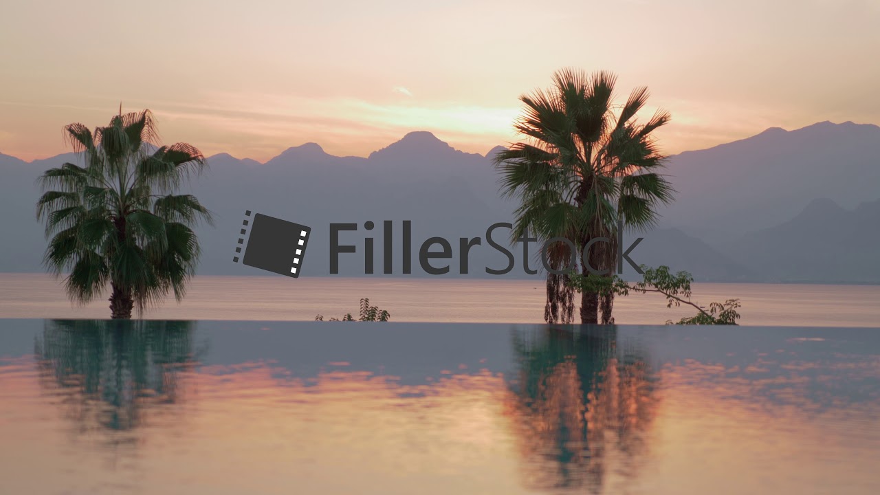 A reflective swimming pool boundary and an evening sea scenery