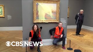 Climate activists throw mashed potatoes on a Monet painting to protest fossil fuel extraction