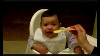 Funny baby eating carrots for the first time