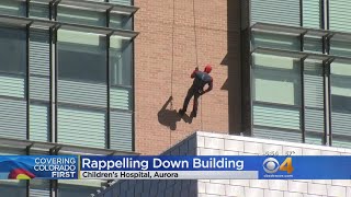 Superheroes Rappel Down Side Of Hospital For Young Patients