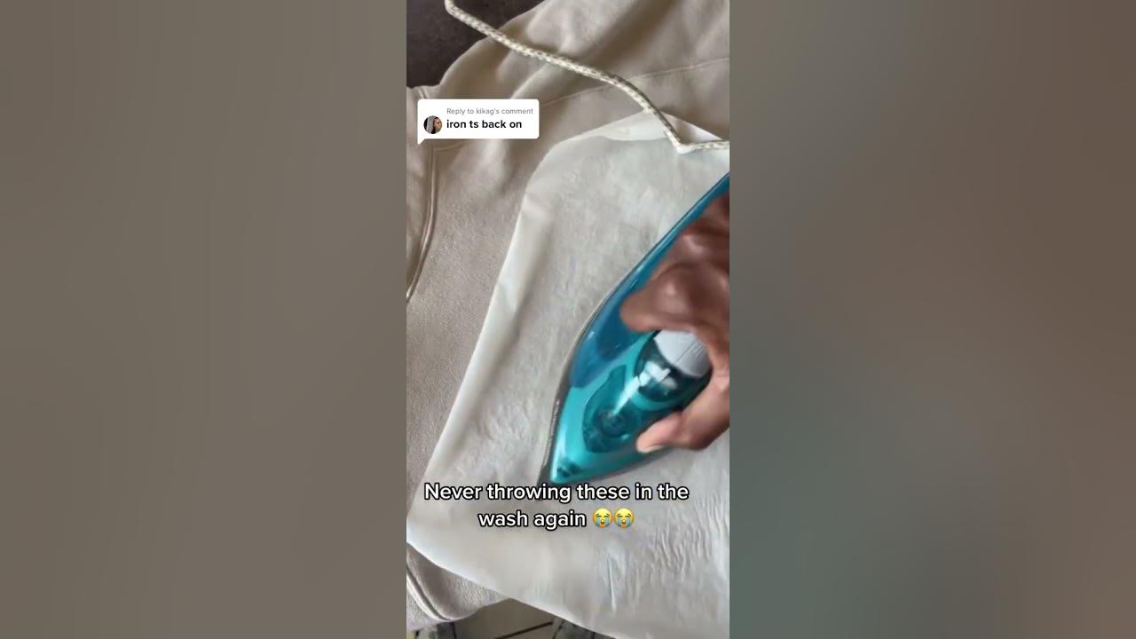 Man irons the letters back onto his hoodie after they came off in the wash!