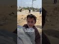 Palestinian child struggles to move sack of flour in Gaza