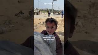 Palestinian child struggles to move sack of flour in Gaza