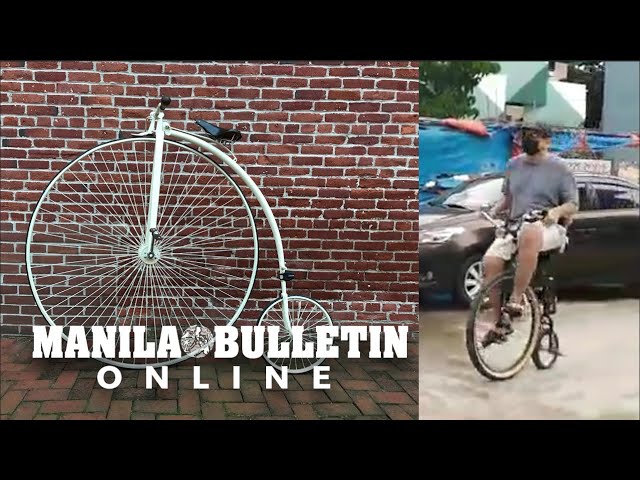 Businessman rides a modern version of the 1870s penny-farthing bicycle in downtown Davao City