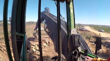 John Deere loading log trucks