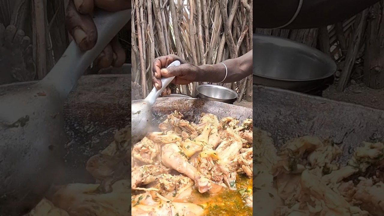 Turkana Tribe Woman Cooking Chicken for her Children in the Desert 