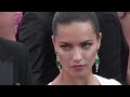 Adriana Lima stuns in white as she walk the red carpet for the Premiere of Julieta in Cannes