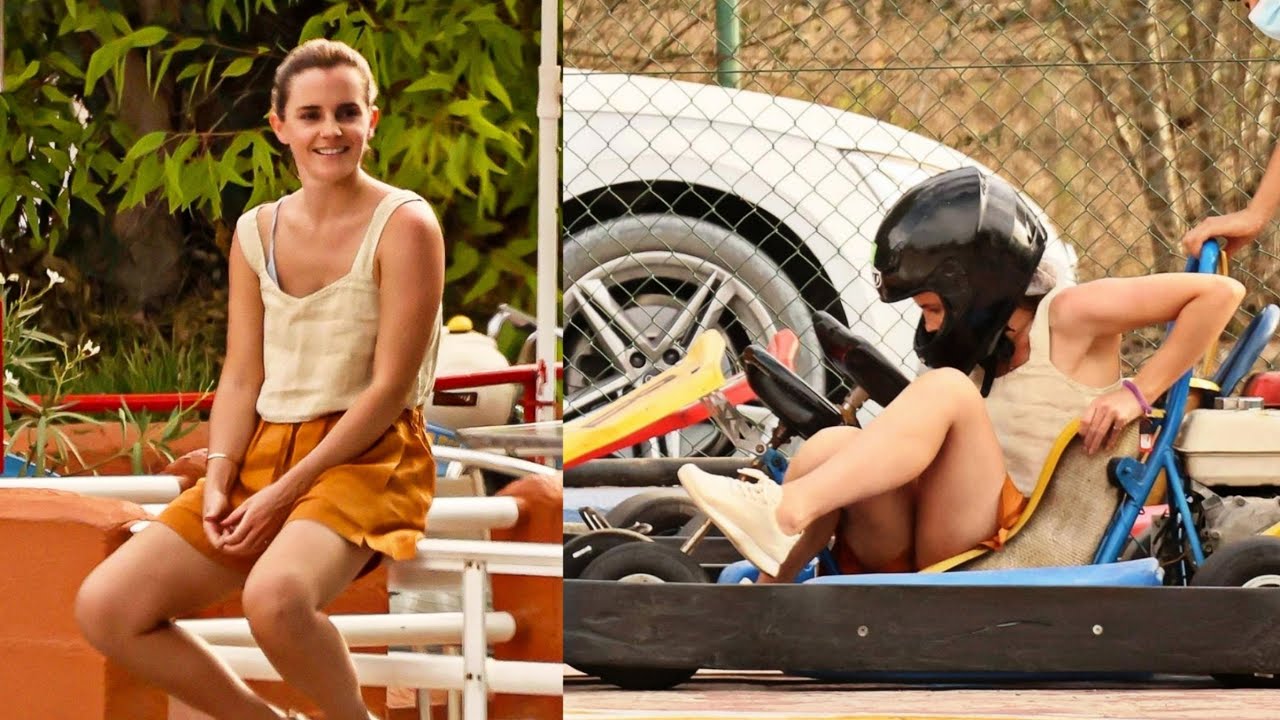 Emma Watson puts on a racing helmet and in orange shorts and a vest