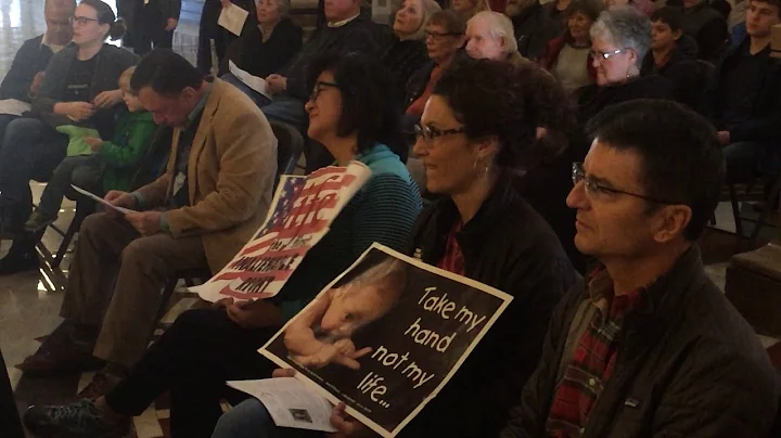 Pro-life supporters listen to Rev. Donald Mayes at...