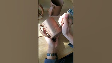 sliptrailing with a henna cone on pottery mugs. wheat design