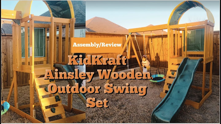 Swing set with slide and rock wall