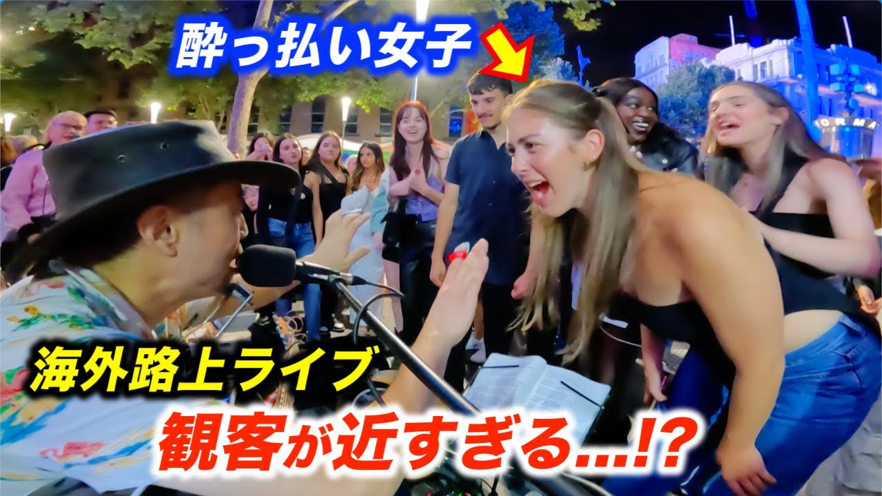 酔っ払った女子が路上ライブのトーク中に乱入...!?日本人ストリートミュージシャンと海外の観客の会話が楽しすぎる！