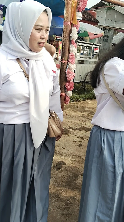 mothers wearing high school uniforms taking part in the carnival