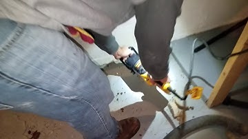 Using auger to dig suction pit for radon mitigation