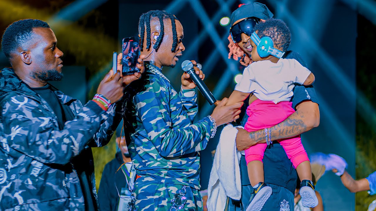 Fik Fameica's baby is brought onto the stage in support of his father concert