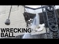 Wrecking ball in action demolishing a concrete building