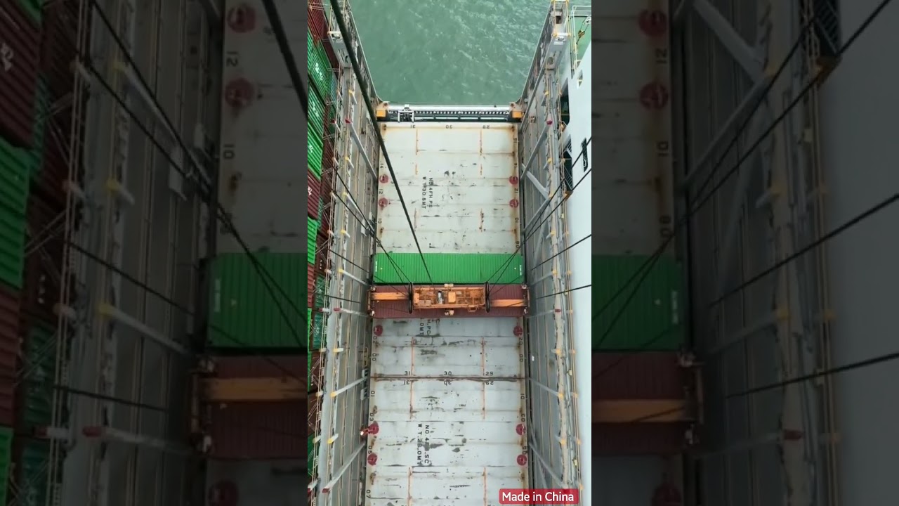 overhead doc crane lifting up 40ft container | ever green container