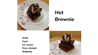 Hot brownie with cool ice cream over chocolate dripping