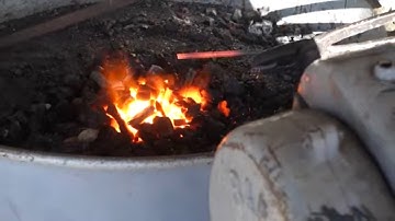 Blacksmith forging a  hook