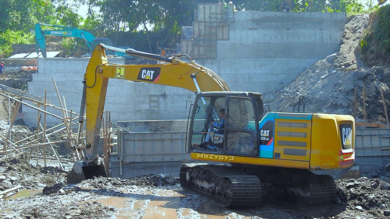 CAT Kobelco Excavator Working on the River Flood Dam Construction - YouTube